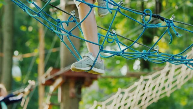 Feet strode on a rickety grid stretched high above the ground