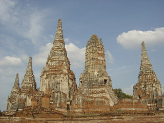 Fototapeta premium Old historic scenic Buddhist temple ruins with tall stone towers and sky copy space in Ayutthaya Thailand