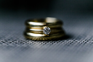 golden wedding bands and engagement ring with diamond