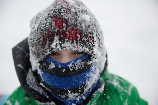 Portrait of teenage boy wearing frozen warm clothing during winter