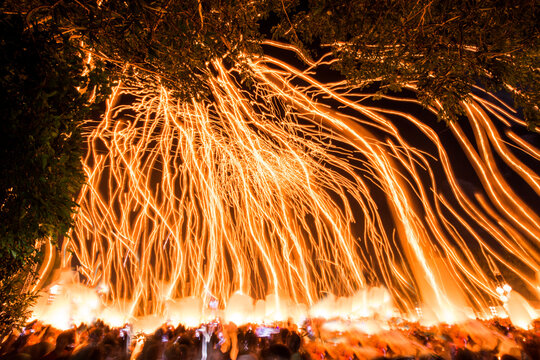 Low angle view of fire poles over crowd during Yi Peng Festival