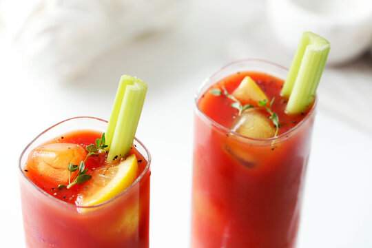 High angle view of Bloody Mary served with lemon and celeries on table