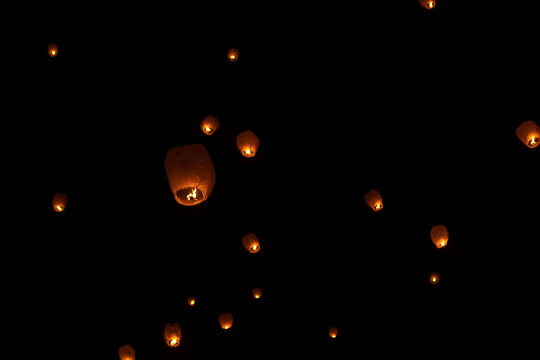 Low angle view of illuminated lanterns flying against sky at night during Chinese New Year