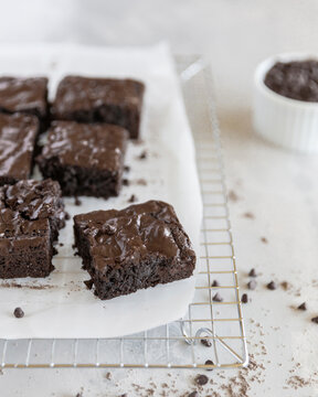 High angle view of brownies with wax paper on cooling rack