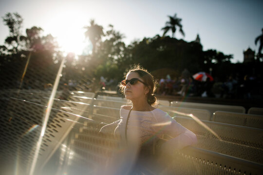 Teenage girl wearing sunglasses while standing by barricades against sky