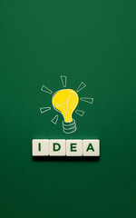 the word idea is composed of letters on a green background. Light bulb and word idea. Creativity inspiration ideas concept and innovation concept