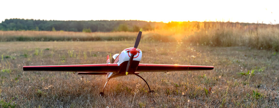 airplane model on the runway at sunset