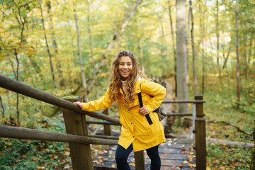 Naklejka na ściany i meble Portrait of young woman walking in the forest. Travelling, lifestyle, adventure.