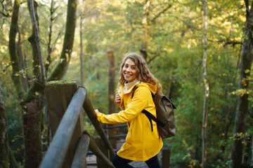 Portrait of young woman walking in  the forest. Travelling, lifestyle, adventure.