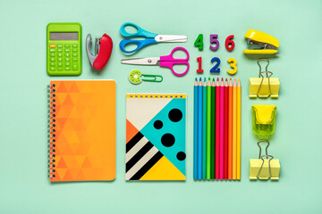 Frame from school and office supplies Paper clips, pens, calculator, sharpener, notepad, stapler isolated on green background Flat lay Top view Back to school, education concept Mock up Copy space