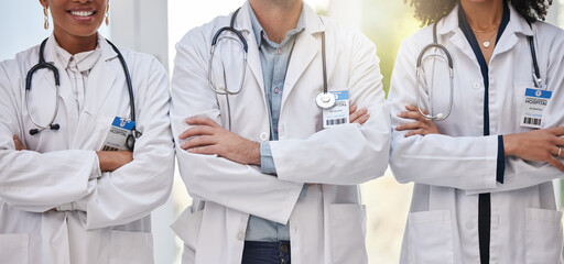 Team of doctors, healthcare collaboration and support with motivation, medical professional group and innovation. Health, teamwork and surgeon people with arms crossed in hospital, help and trust