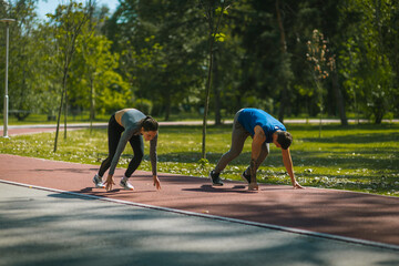Two athletes are about to start jogging