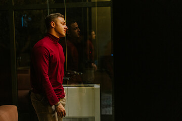 Tired male person is preparing to leave the office after rough day at work