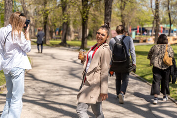 Happy young people walking down the city street