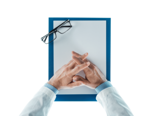 Doctor with hands clasped waiting at desk