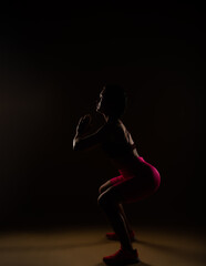 Fototapeta na wymiar Sporty woman doing squats