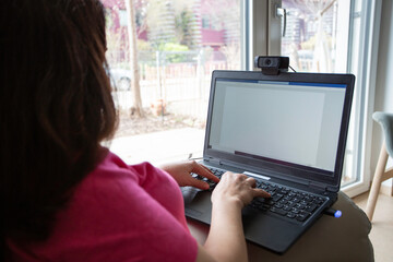 Close up of laptop screen with woman working
