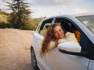 Woman on road trip traveling by rental car