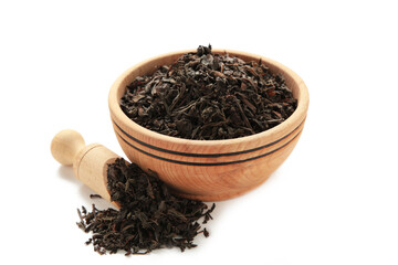Dry tea leaves in bowl isolated on white background.
