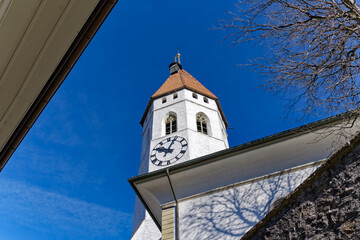 Old town of City of Thun with white city church on a hill on a sunny winter day. Photo taken February 21st, 2023, Thun, Switzerland.