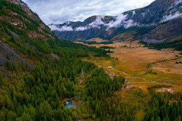 Aerial landscape Altai melancholic mood, blue geyser lake, mountains Altay Russia drone view