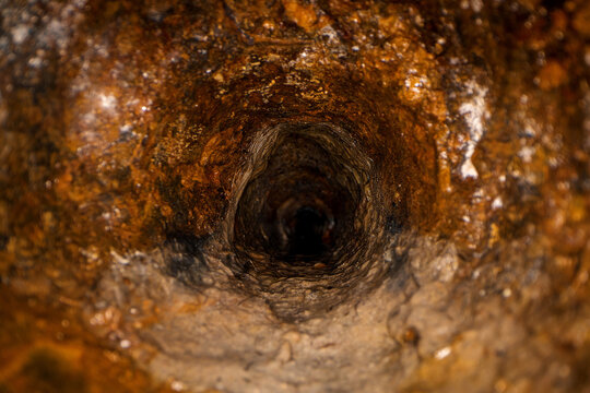 inside old dirty sewer line pipe. rusty casting iron drain tube