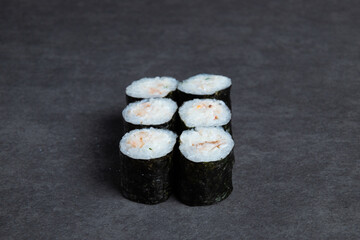Sushi rolls on a black background, close-up, top view