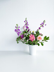 bouquet flowers in white vase. dianthus. daylight