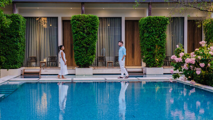 Luxury 5 star hotel pool in Asia. A couple of men and women on vacation at a luxury hotel resort, men and women by the pool