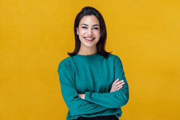 Beautiful woman smiling while looking at camera on isolated on yellow