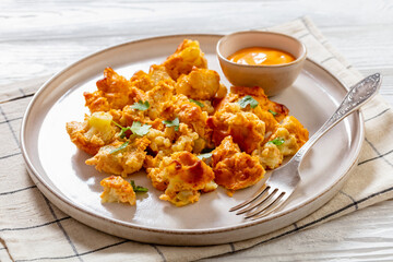 baked Cauliflower florets with sauce on plate