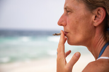 woman smoking a joint on the beach