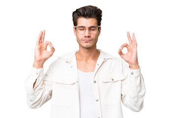 Young handsome caucasian man over isolated background in zen pose