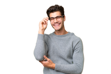 Young handsome caucasian man over isolated background with glasses and happy