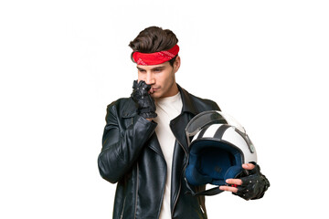 Young caucasian man with a motorcycle helmet over isolated background having doubts