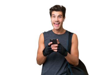 Young sport caucasian man with sport bag over over isolated background surprised and sending a message