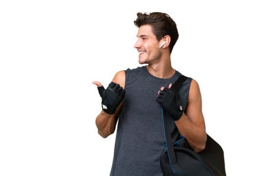 Young sport caucasian man with sport bag over over isolated background pointing to the side to present a product