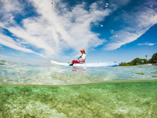 woman kayaking in clear tropical sea summer fun