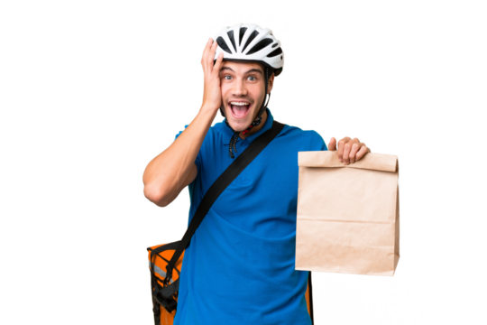 Young caucasian man taking a bag of takeaway food over isolated background with surprise and shocked facial expression