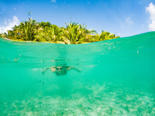 Fototapeta na wymiar woman snorkeling in clear tropical sea