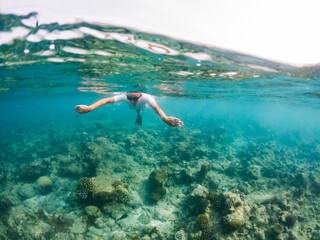 woman snorkeling in clear tropical sea