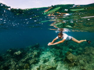 woman snorkeling in clear tropical sea