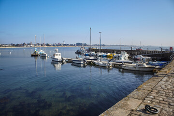 Fototapeta na wymiar Port Louis, Bretagne, France : Beautiful picture of the port of Port Louis, near Lorient. Calm and blue sea, beautiful sky very sunny, old stone dike