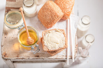 Sweet buns with honey and milk in bottle.