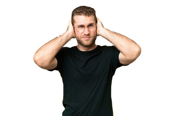 Fototapeta na wymiar Young handsome blonde man over isolated chroma key background frustrated and covering ears