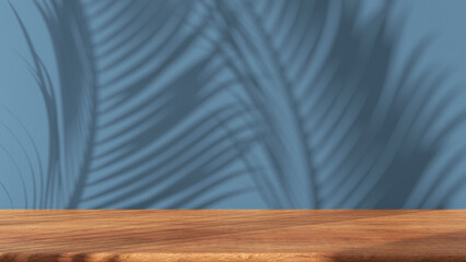 Wooden table with blue stucco wall background with window light and palm leaves shadow. Product presentation mock up. Empty interior design concept