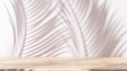 Bleached wooden table with white stucco wall background with window light and palm leaves shadow. Product presentation mock up. Empty interior design concept