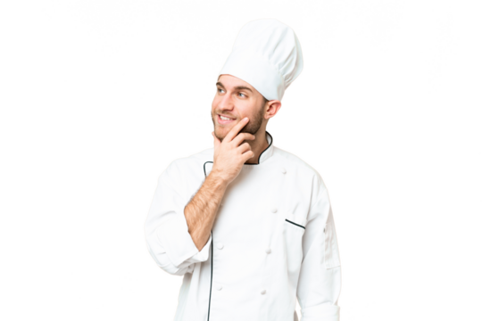 Young blonde man Chef over isolated chroma key background thinking an idea while looking up