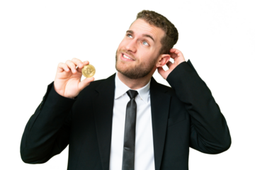 Young business blonde man holding a Bitcoin over isolated chroma key background having doubts