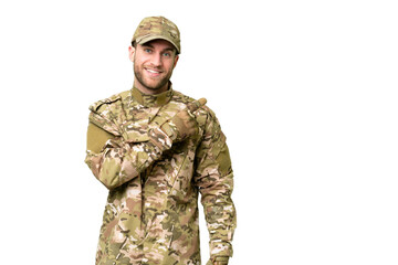 Military man over isolated chroma key background pointing to the side to present a product